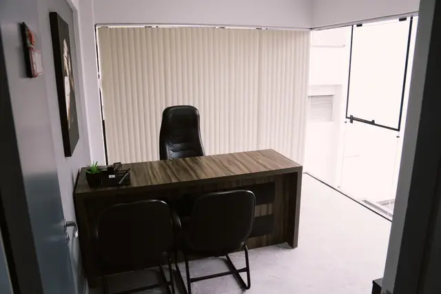 Sala 209 da Willtay Coworking em Brusque: mesa de madeira com cadeira executiva e cadeiras para visitantes